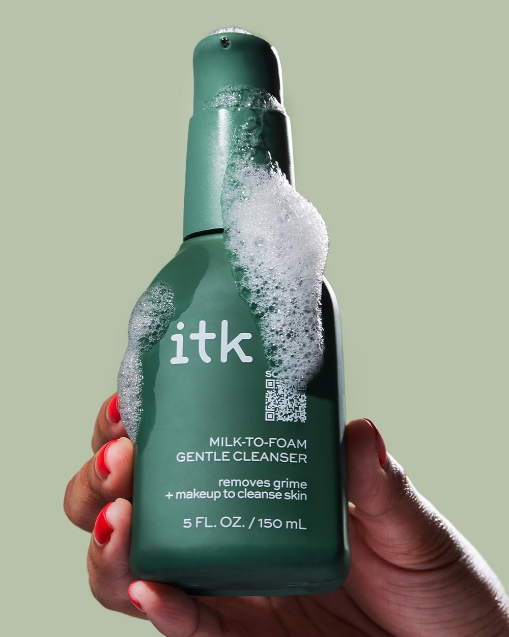 ITK cleanser held in hand to show size and travel-friendly scale