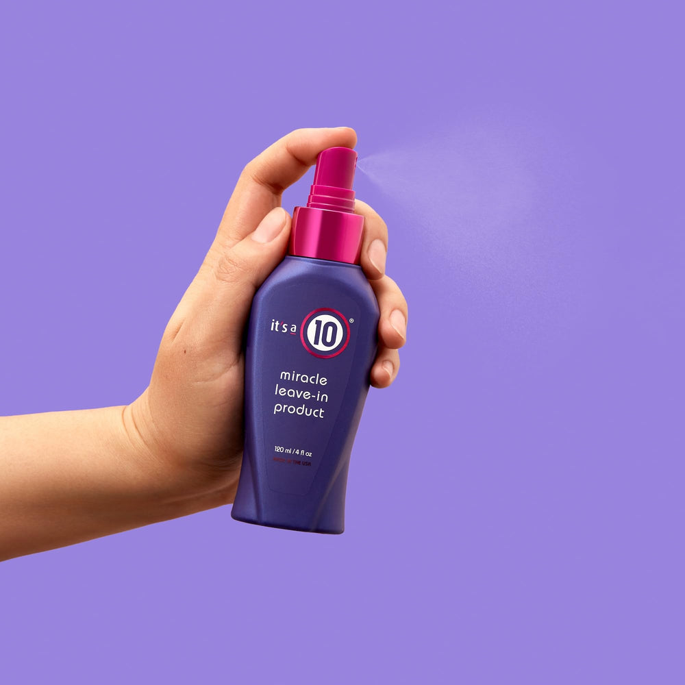 It's A 10 Miracle Leave-In held in hand for scale illustrating the 4 oz portable convenience