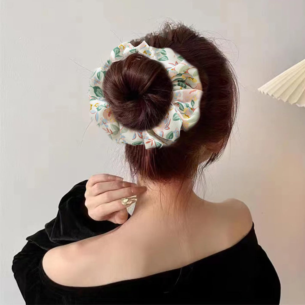 Jaczora scrunchie next to a coin to show scale and fit benefit