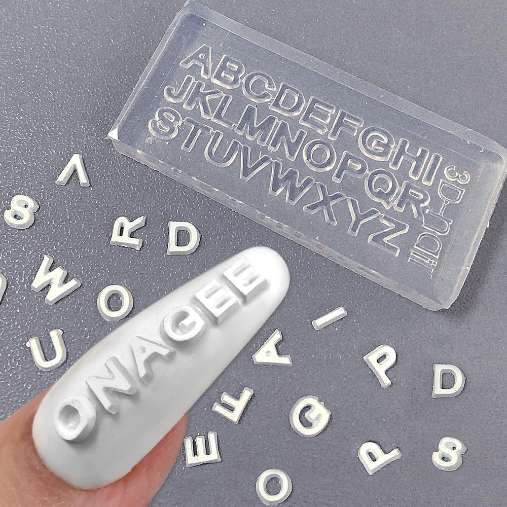 Jaliya tiny resin letters applied to nail tips for customized manicure accents