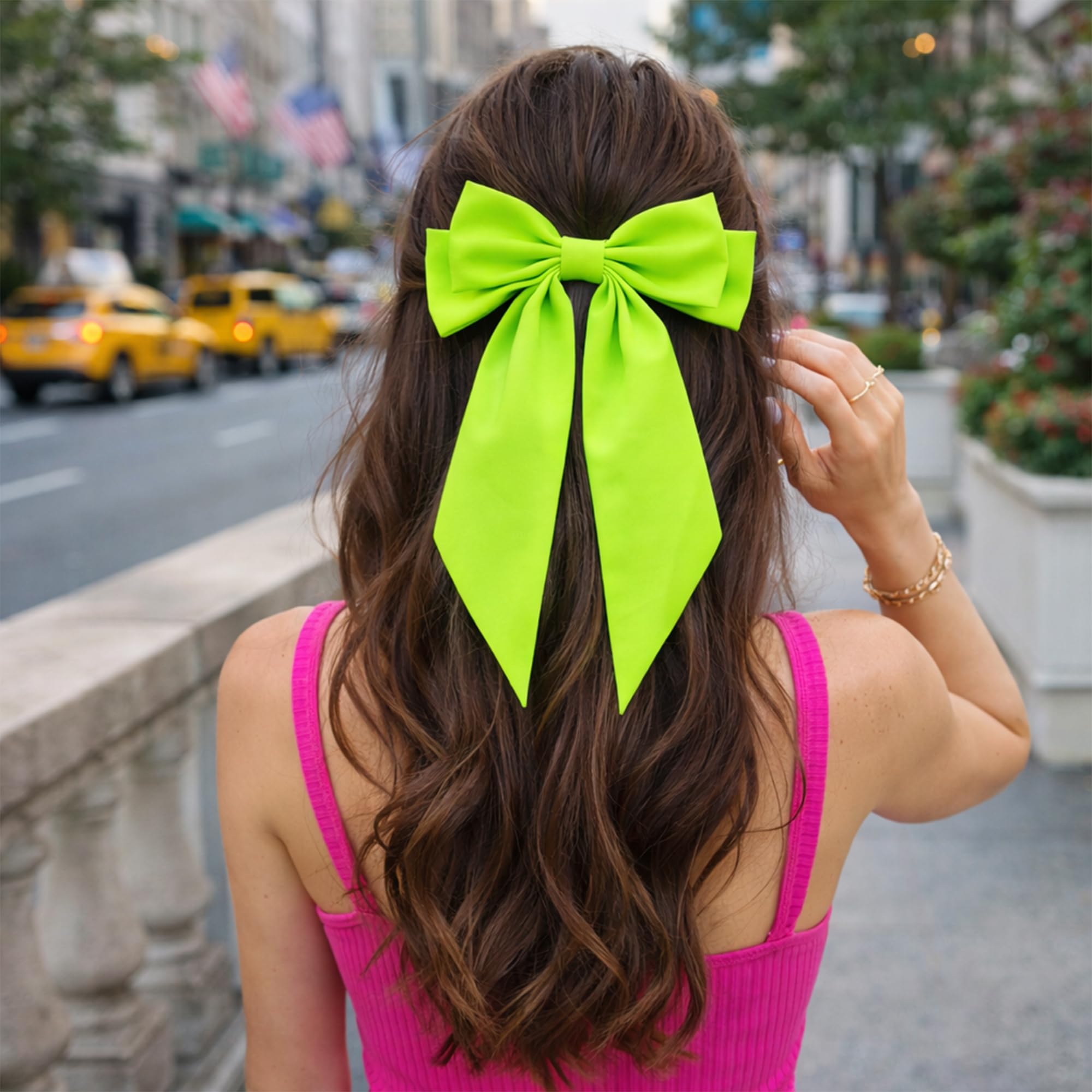 JazSwirl bow next to hand for scale showing true oversized statement benefit