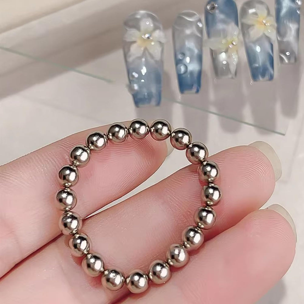 JERCLITY magnet ring next to a coin for scale showing compact portability