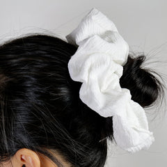 JGQUR scrunchie worn on wrist as accessory and easy storage
