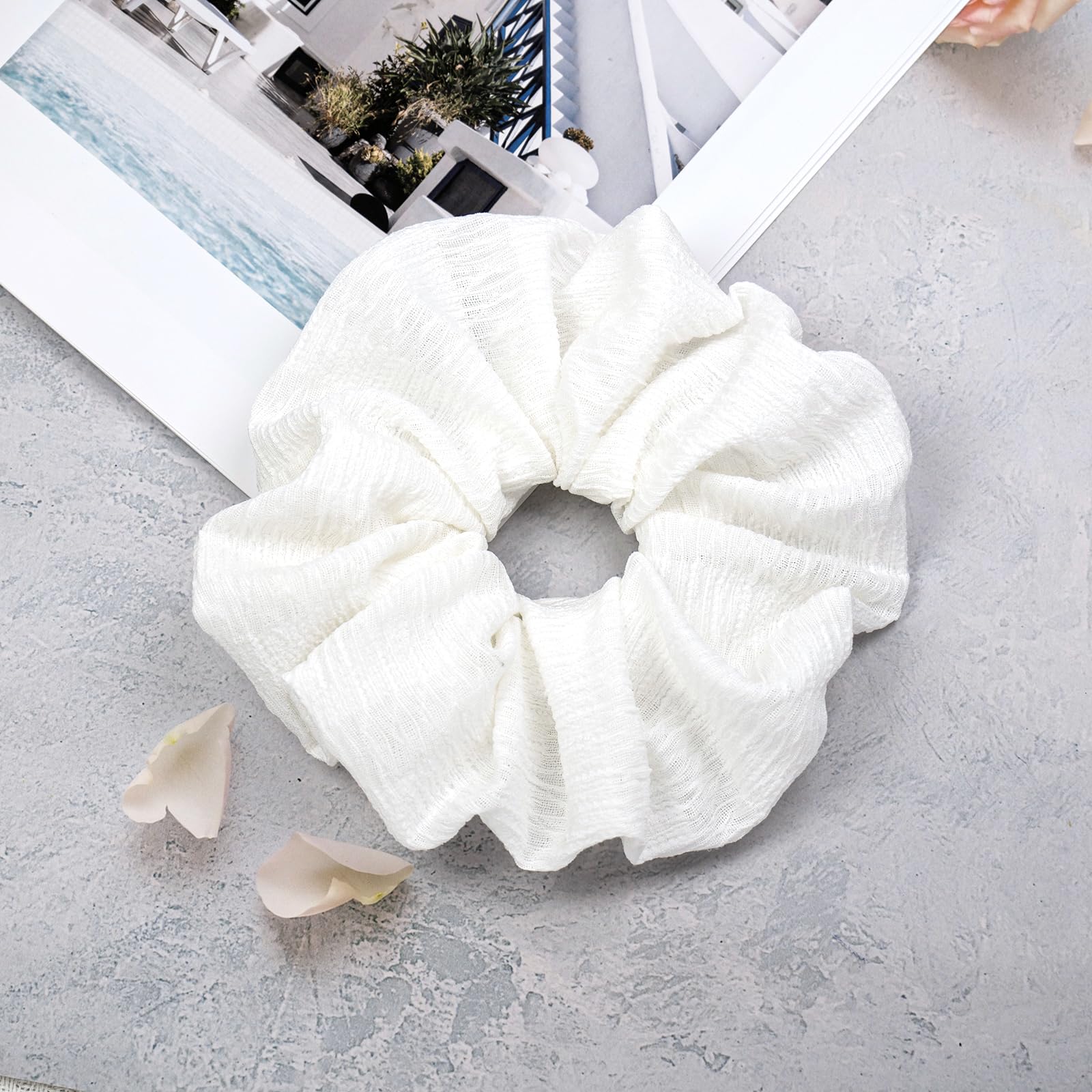 JGQUR scrunchie next to a coin for size scale and fit reference
