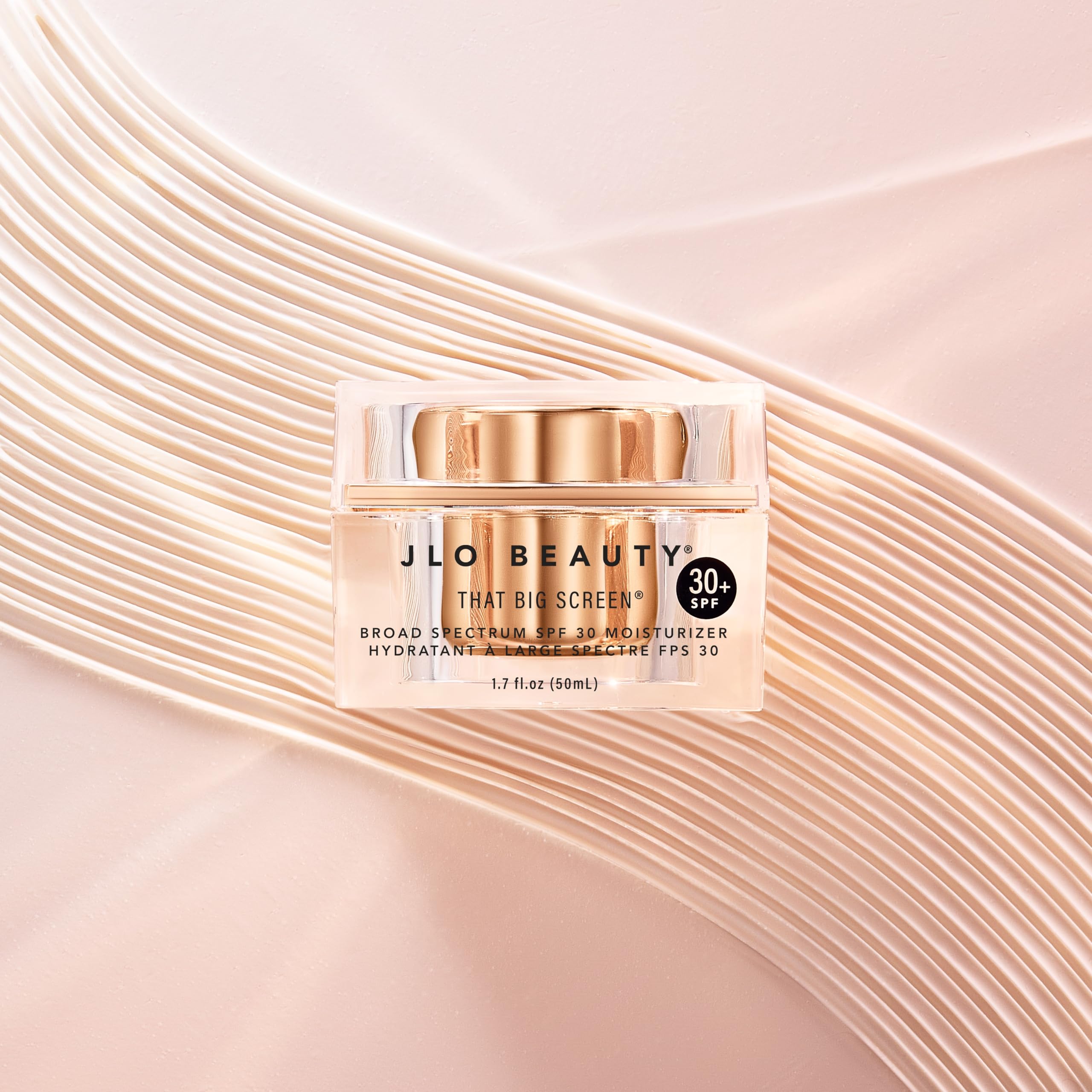 JLO BEAUTY product in hand illustrating 1.7 fl oz scale and portability