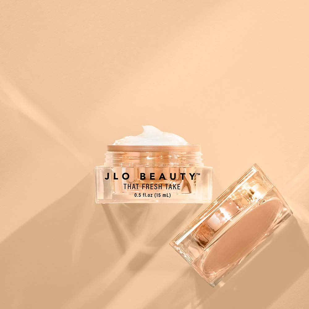 JLO BEAUTY jar next to coin for scale, demonstrates compact 0.5 oz size