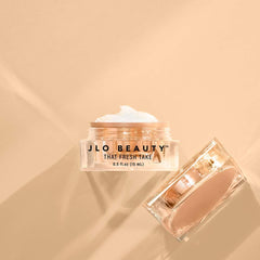 JLO BEAUTY jar next to coin for scale, demonstrates compact 0.5 oz size