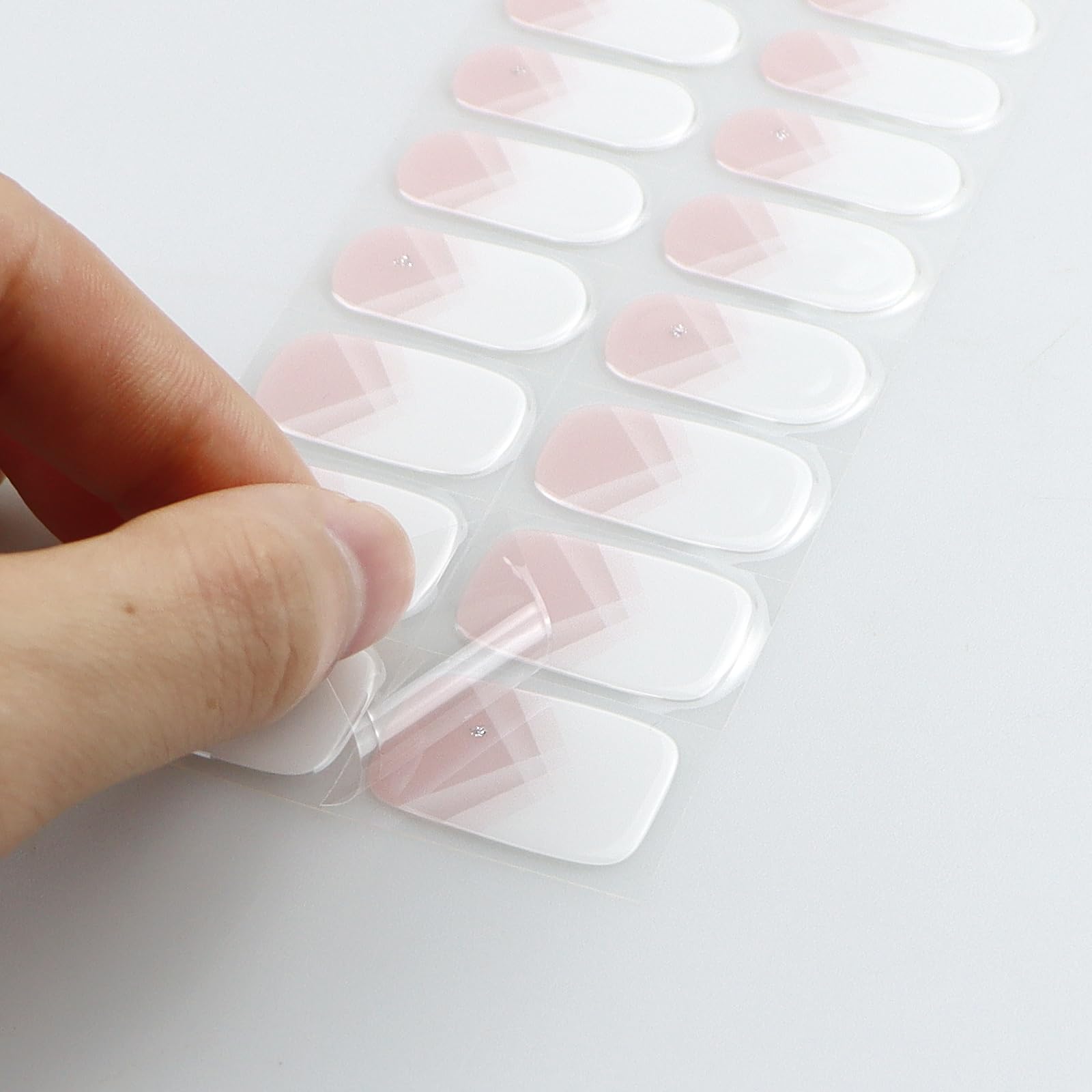 jmeowio applying a gel strip on a fingernail for quick DIY manicure