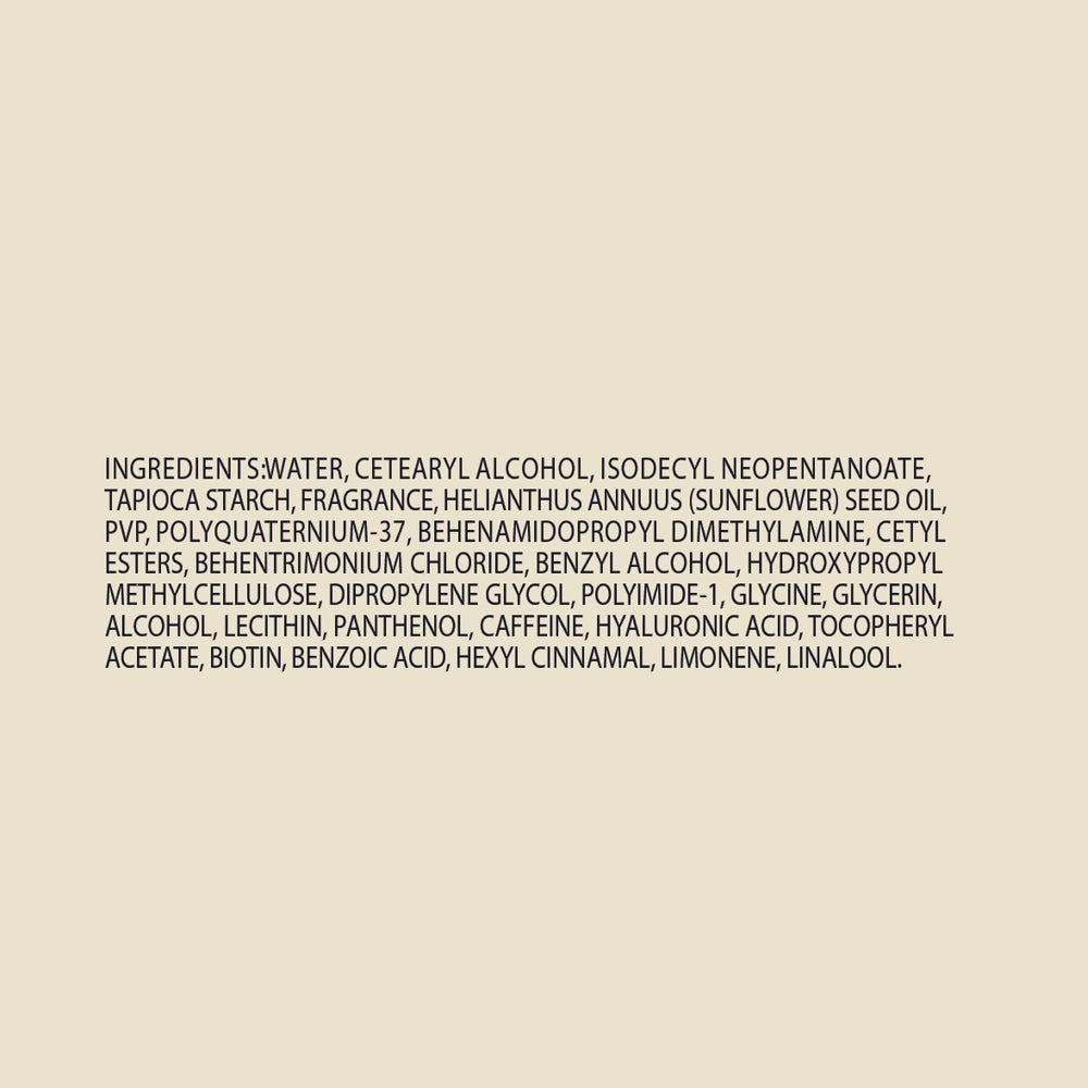 Close-up of John Frieda ingredients label emphasizing biotin and hyaluronic acid benefits
