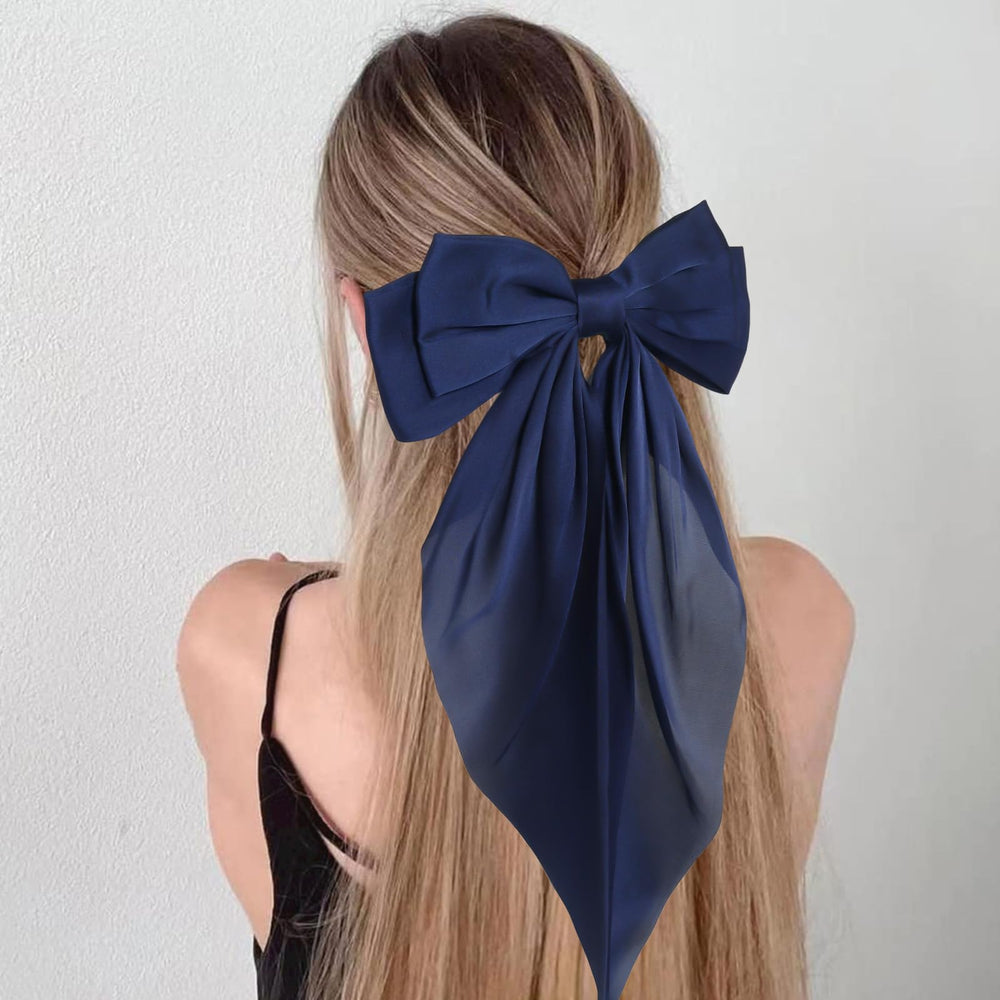 JOYRUBY bow clipped in low ponytail adding polished long-tail detail