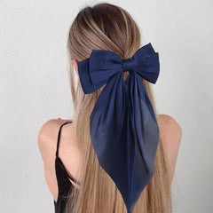JOYRUBY bow clipped in low ponytail adding polished long-tail detail