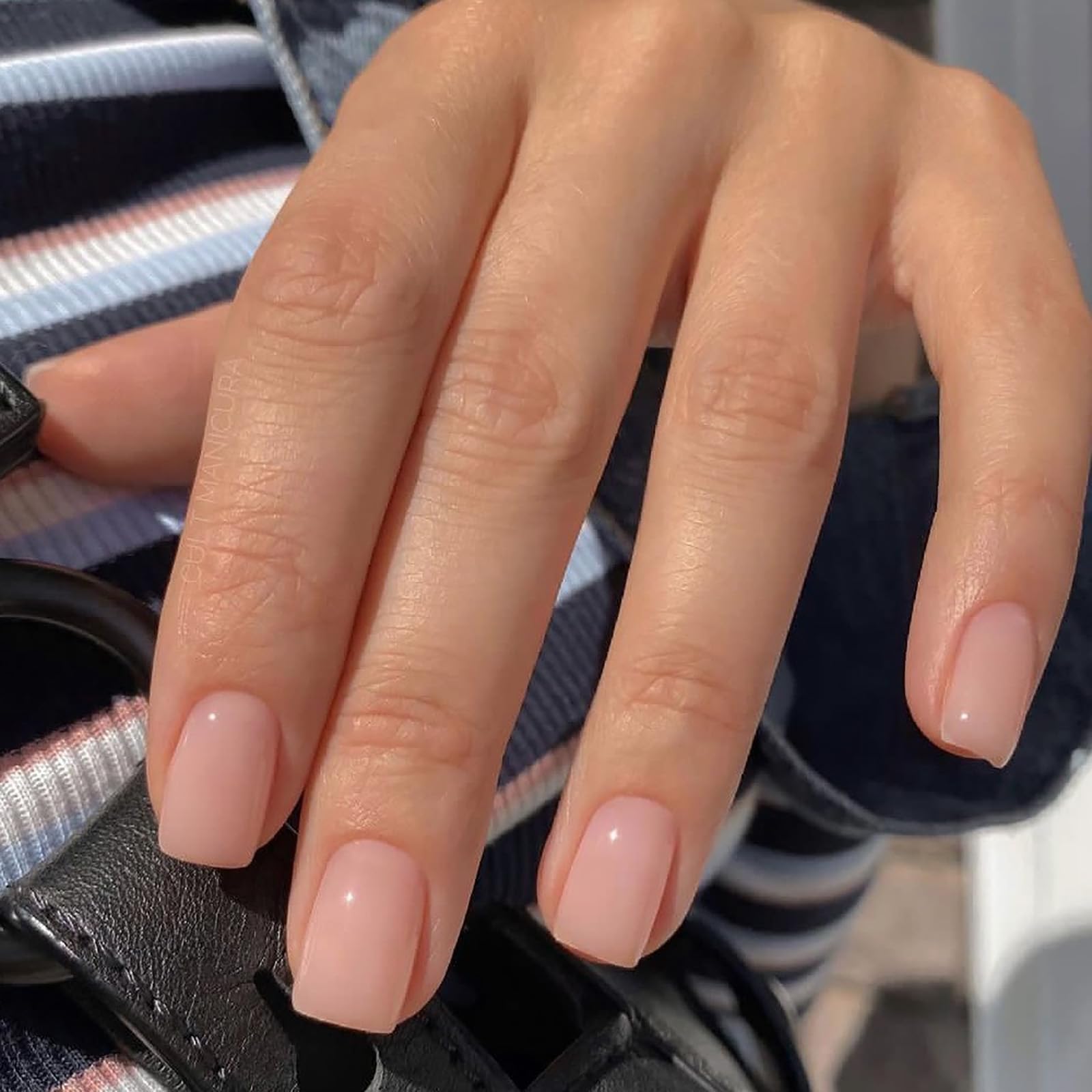Jsiallye close-up of milky white French tip detail showing neat salon finish