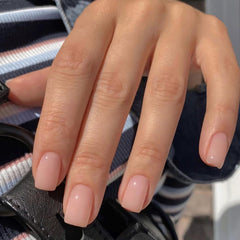 Jsiallye close-up of milky white French tip detail showing neat salon finish