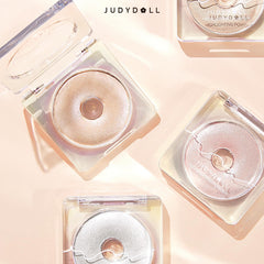 JUDYDOLL compact next to coin showing size and portable travel-friendly benefit