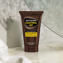 Just for Men bottle beside towel in bathroom conveying maintenance routine benefit