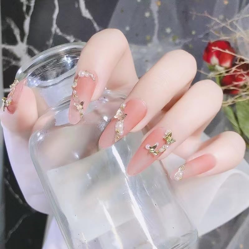 KACHIMOO styled manicure scene showing finished nails with metallic butterflies