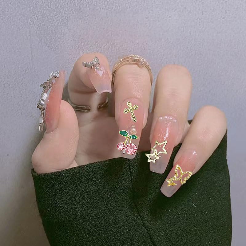 KACHIMOO manicured hands wearing multiple charms in a party setting showing glam styling
