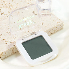 Kaely pan beside coin showing compact travel-friendly size and portability