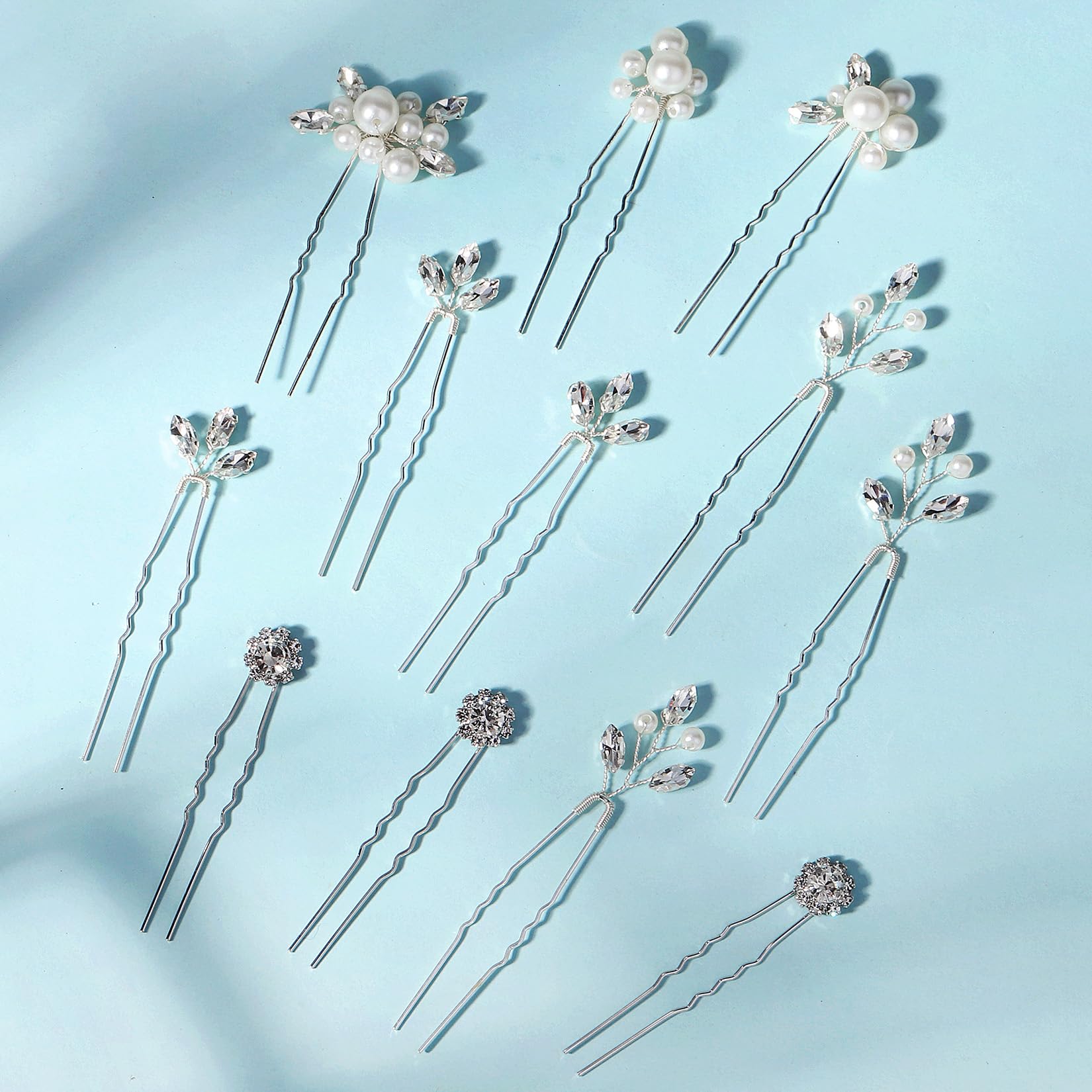 KALOLIA hand holding pins demonstrating compact size and styling scale