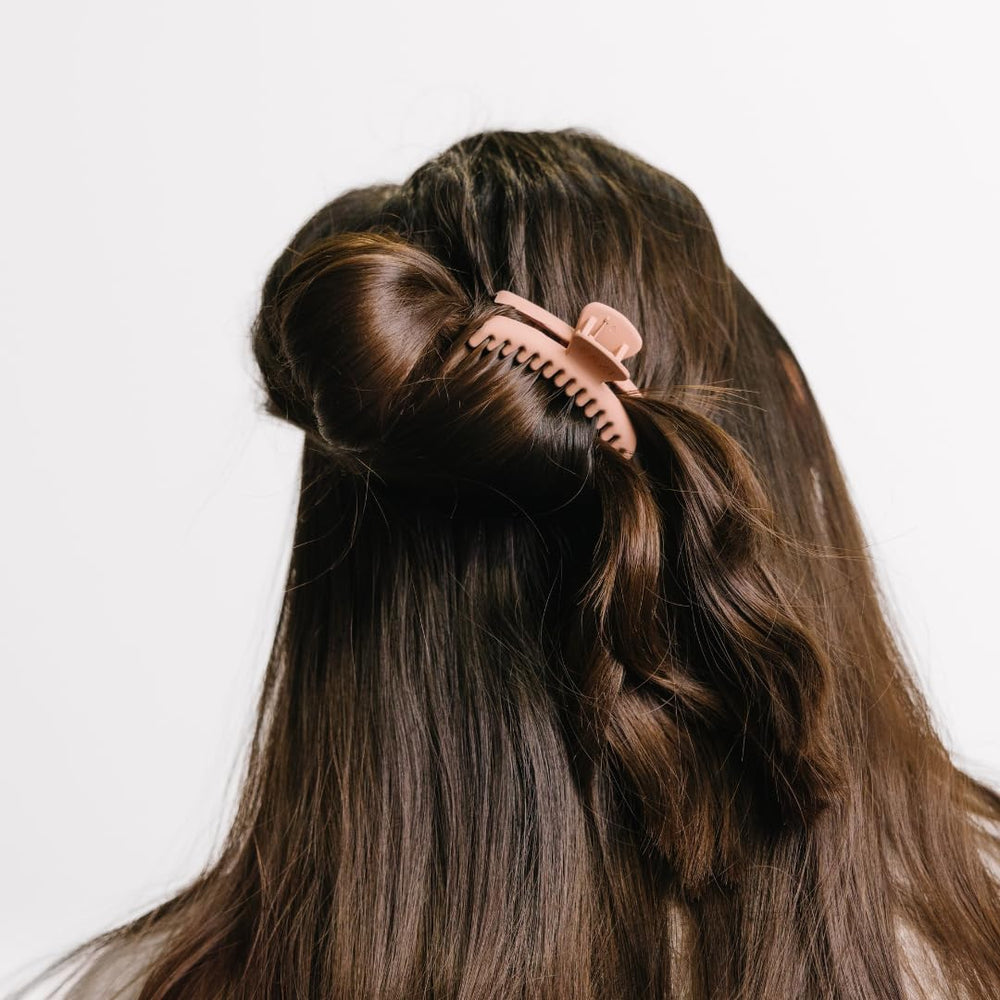 KAXI clip in use holding a bun, showing reliable all-day comfort