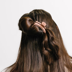 KAXI clip in use holding a bun, showing reliable all-day comfort