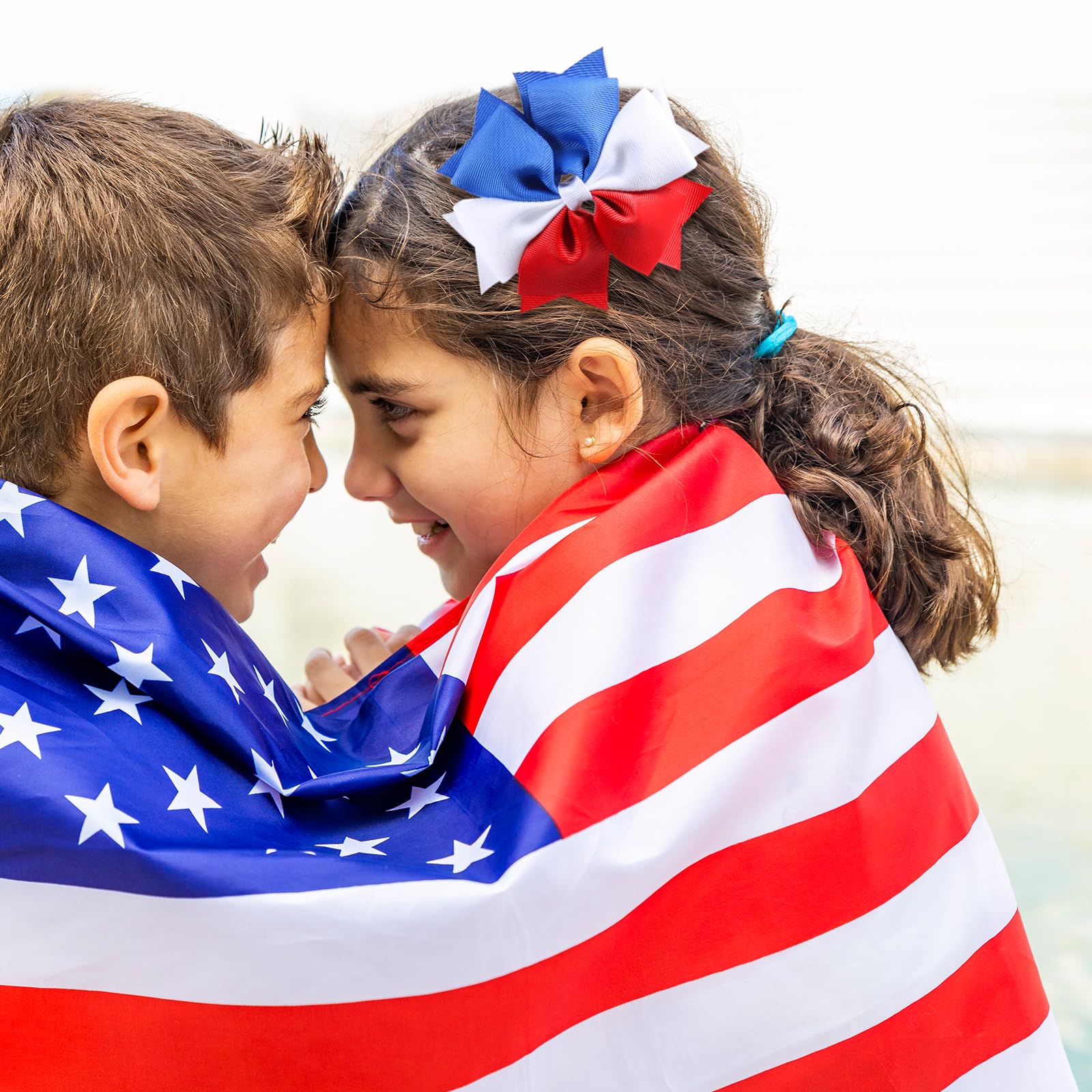 KCHIES bow worn by child in patriotic outfit for festive styling benefit