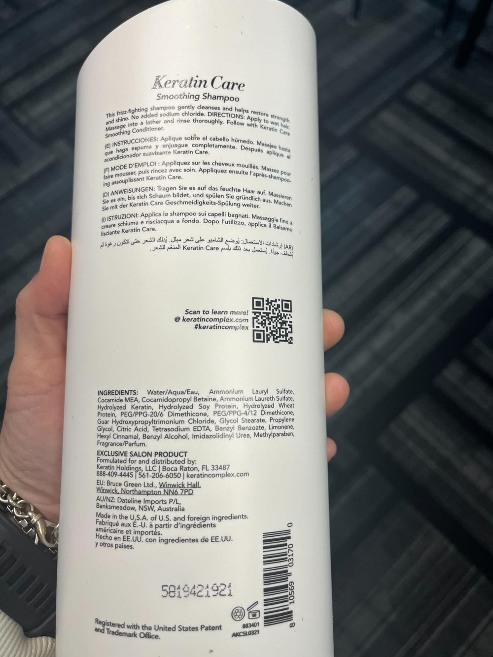 Keratin Complex bottles in hand showing 33.8 fl oz scale