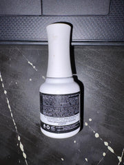 Kiara Sky 15ml bottle next to coin for scale to show compact size