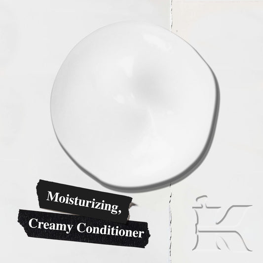 Kiehl's conditioner texture on hand being dispensed, demonstrates smooth spreadability