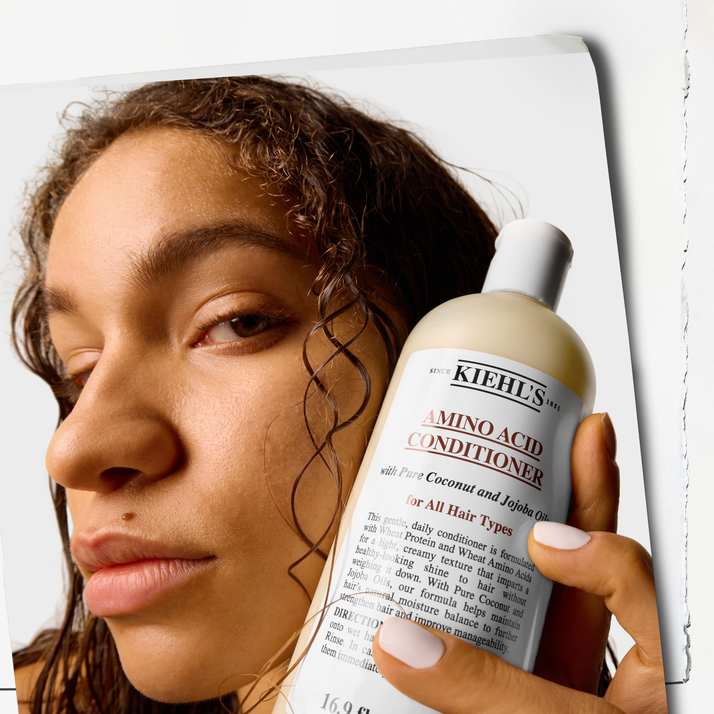 Kiehl's bottle next to hand for scale, conveys 16.9 fl oz travel and value info