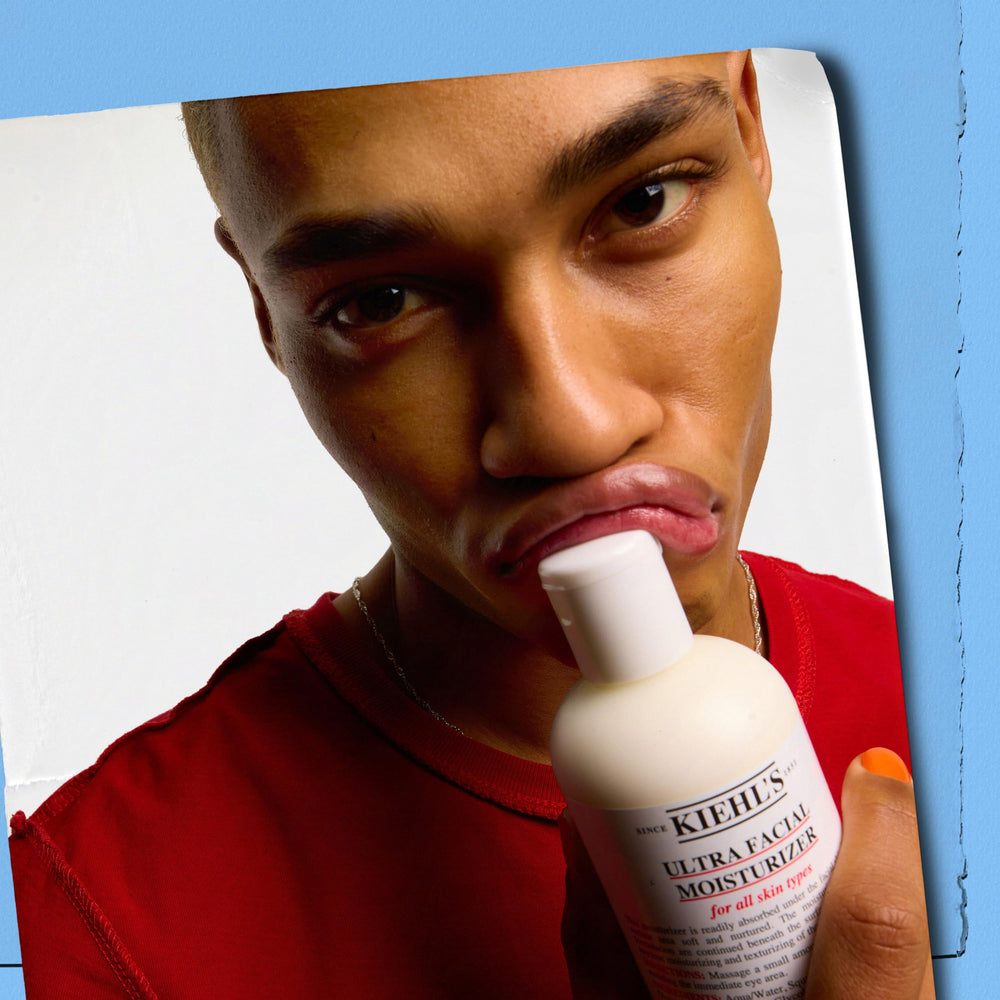 Kiehl's Ultra Facial next to a hand for scale to show the 4.2 fl oz size convenience