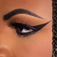 KimChiChic texture swatches on arm showing rich black pigment and blendability