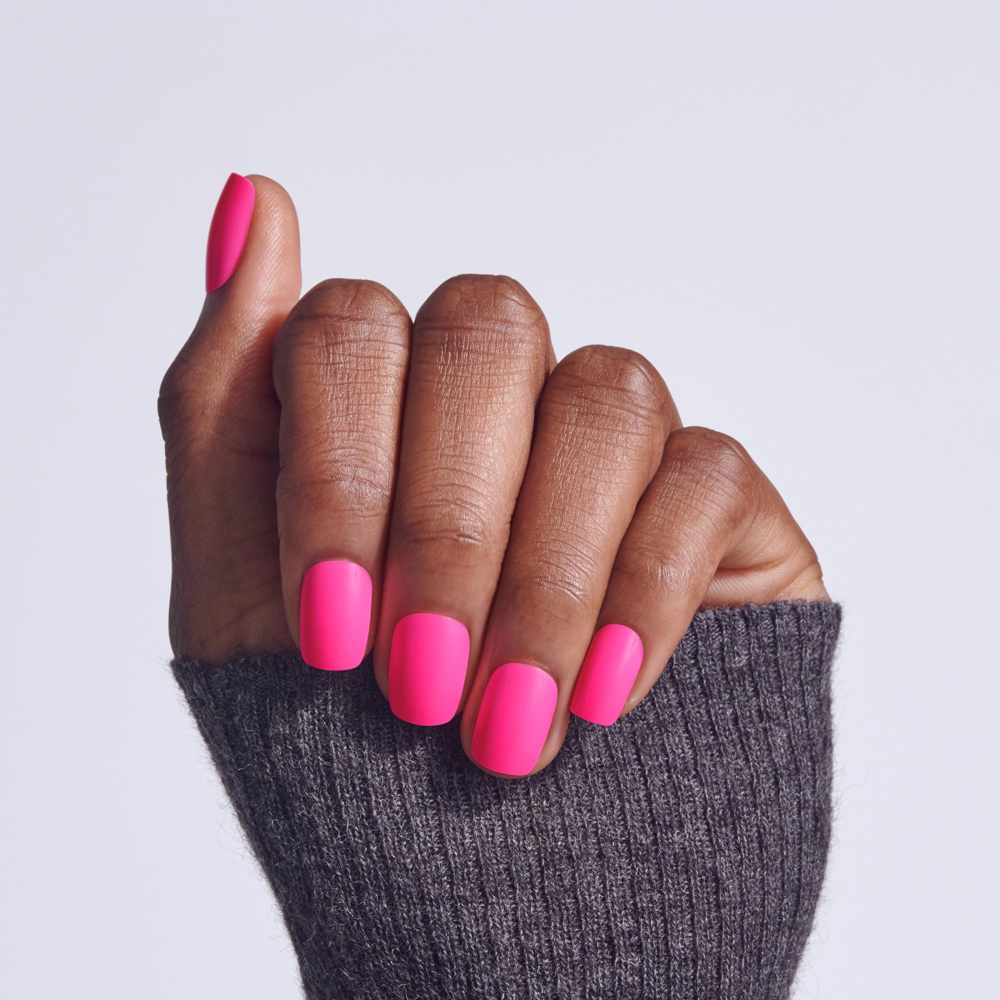 KISS nails on hand in pink short squoval showing instant polished look