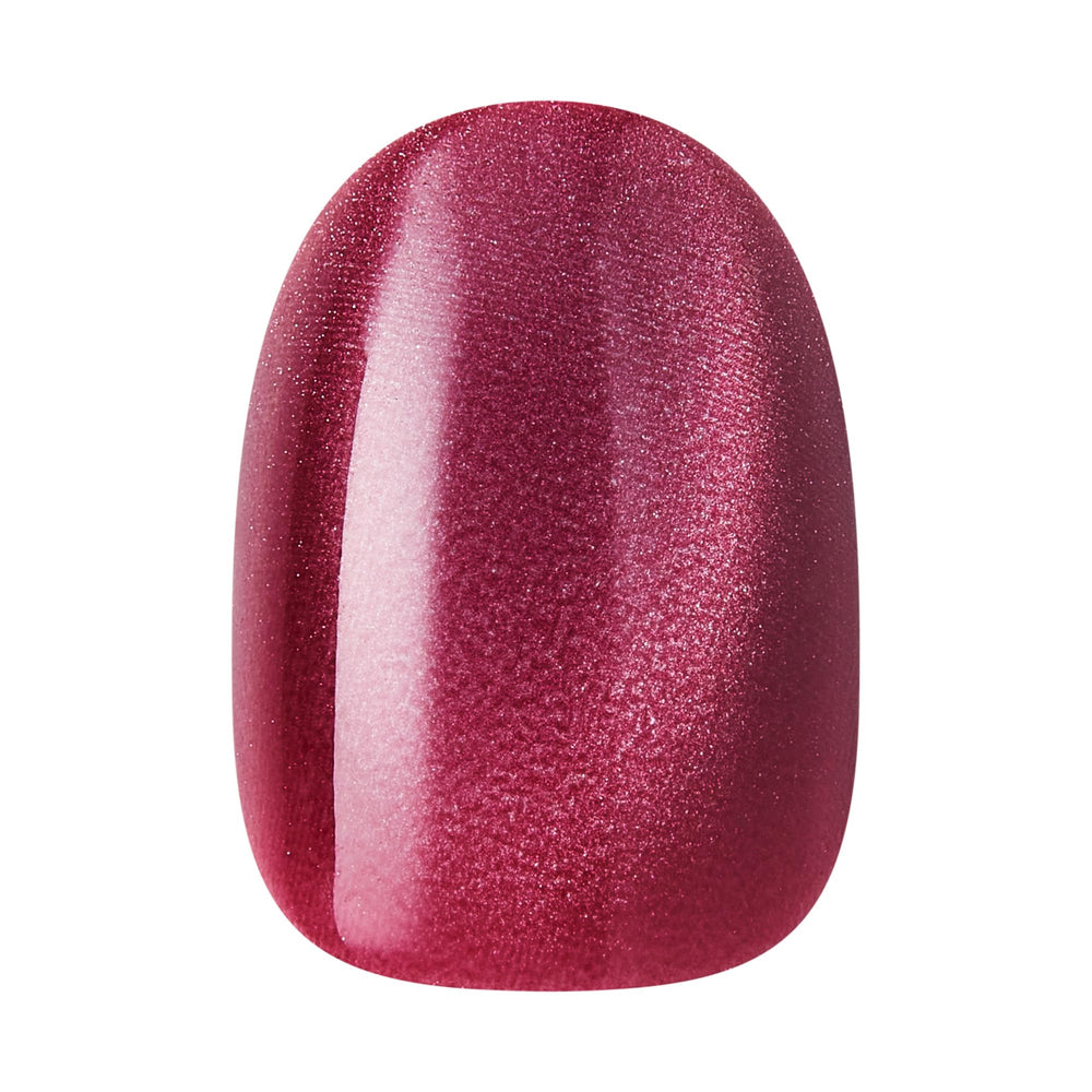 KISS Core nail held in hand to show short round size and realistic scale for wearability
