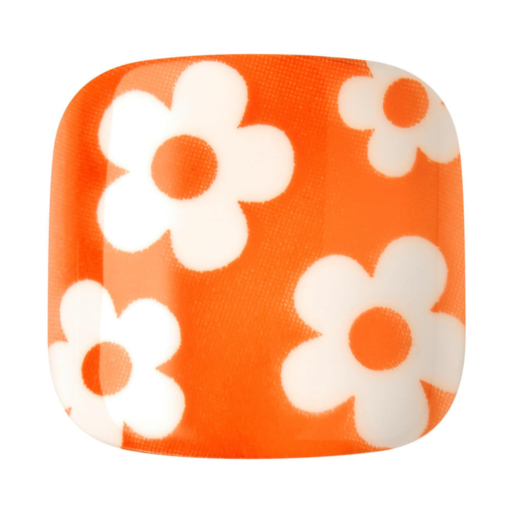 KISS close detail of orange flower and heart French tip showing stylish summer motif