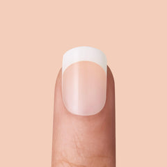 KISS press-on nail being applied to finger for quick salon result