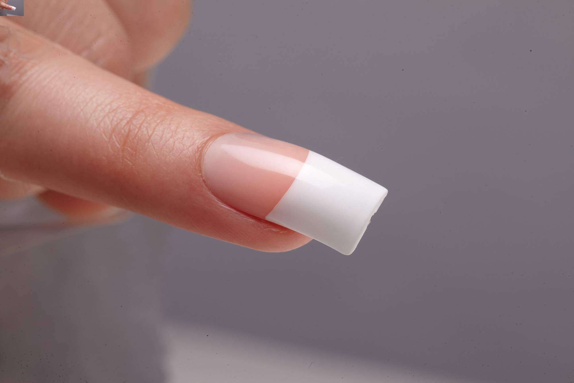 KISS hand applying nails illustrating easy at-home application benefit