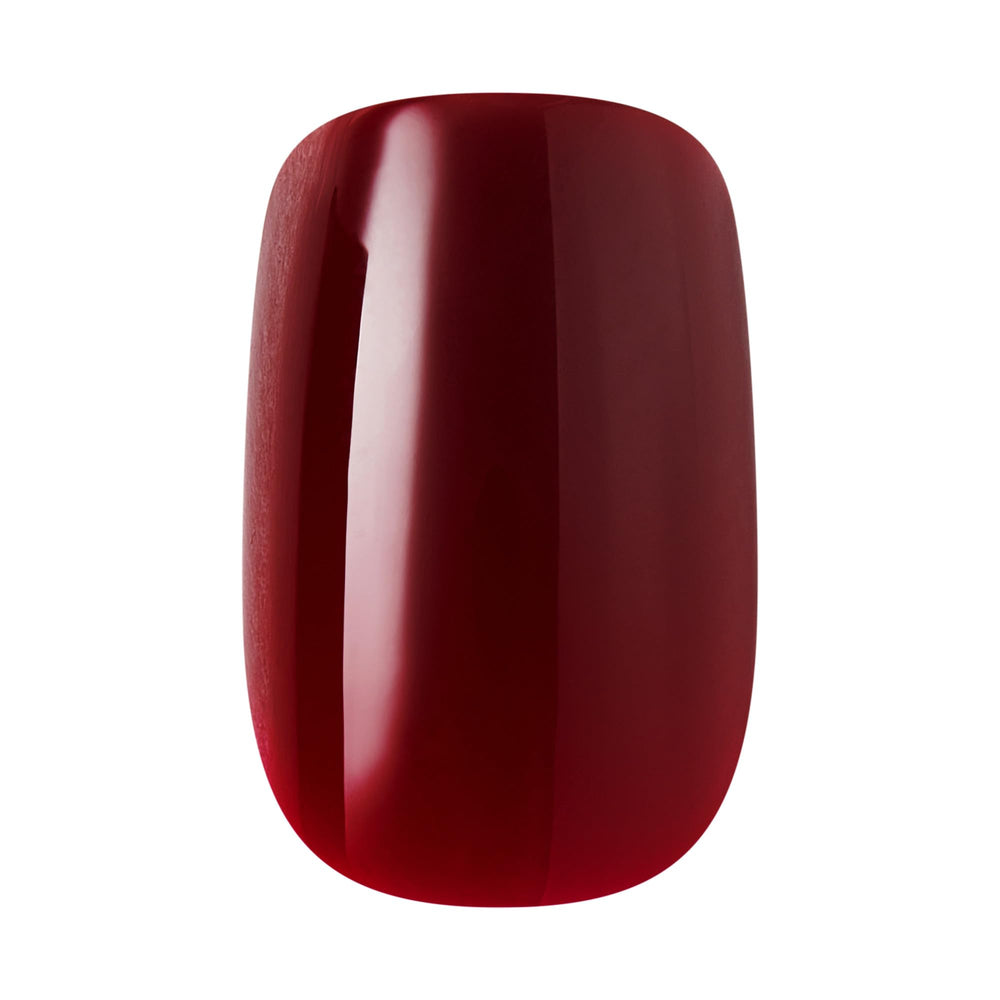 Hands wearing KISS Sprightly red nails in lifestyle setting showing polished everyday look