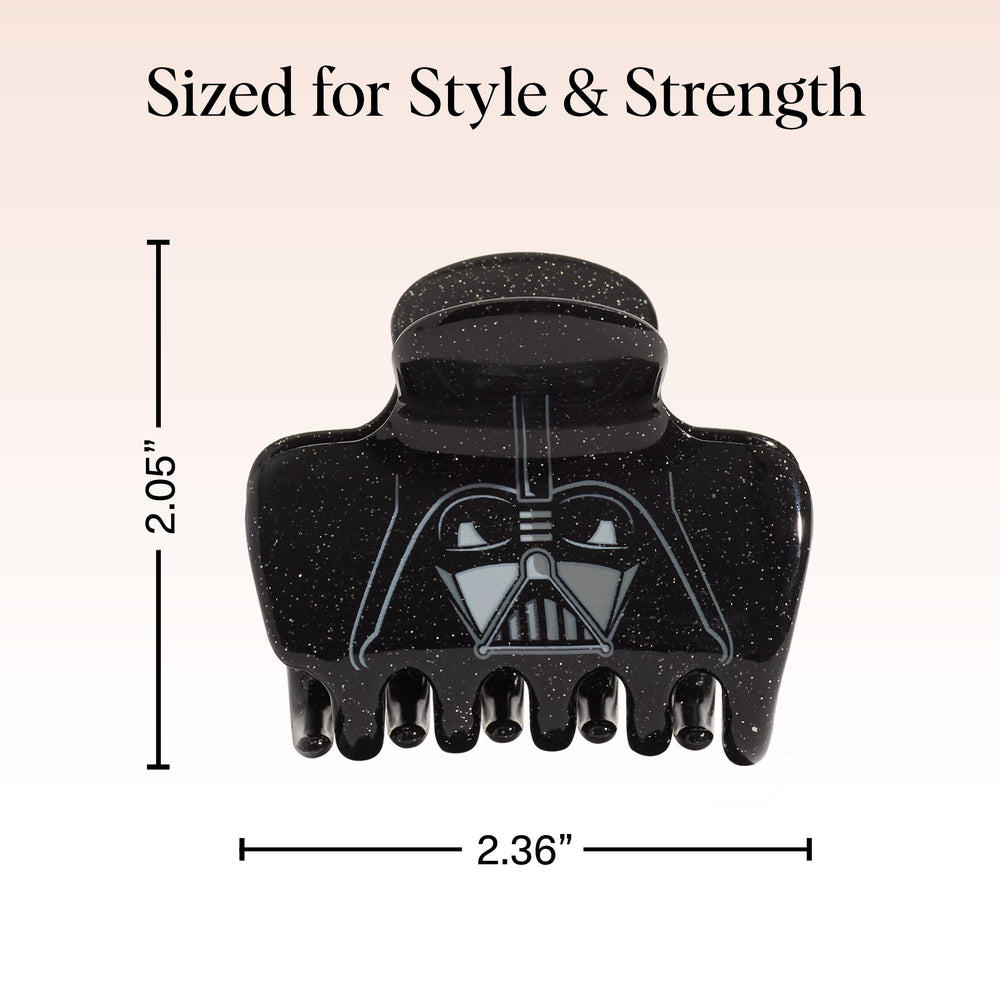 Kitsch Darth Vader next to a credit card for size comparison and travel-ready convenience