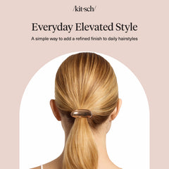 Woman styled outdoors wearing Kitsch gold hair cuff complementing casual-chic outfit