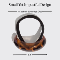 Kitsch cuff shown in hand to display medium size and portability