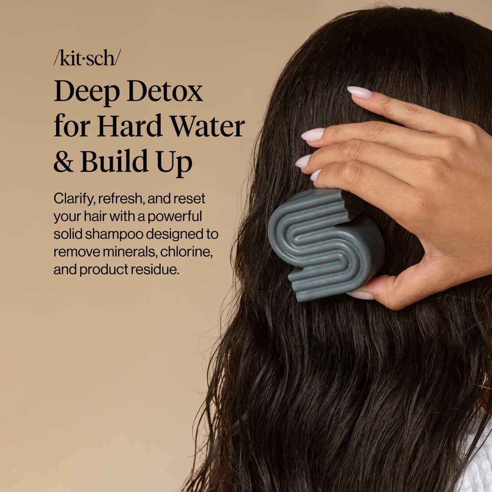 Kitsch shampoo bar held in hand demonstrating compact travel-friendly size