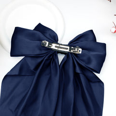 Kivzex bow worn in a half-up hairstyle demonstrating a feminine, polished look