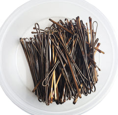 Kleravitex pins securing a bun demonstrating strong hold for active wear
