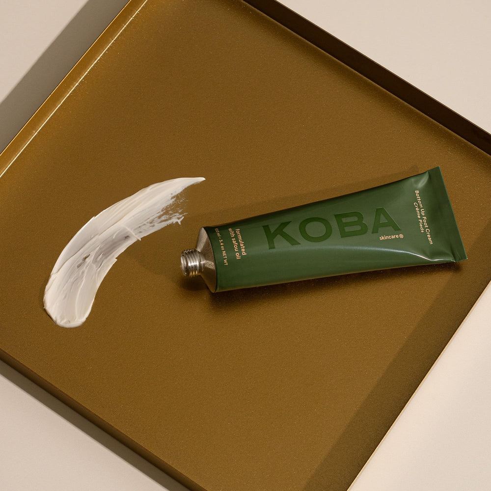Applying KOBA cream to heel to soften cracks and improve comfort