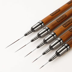 Komall front view brush set showing five wooden-handled liner brushes for versatility