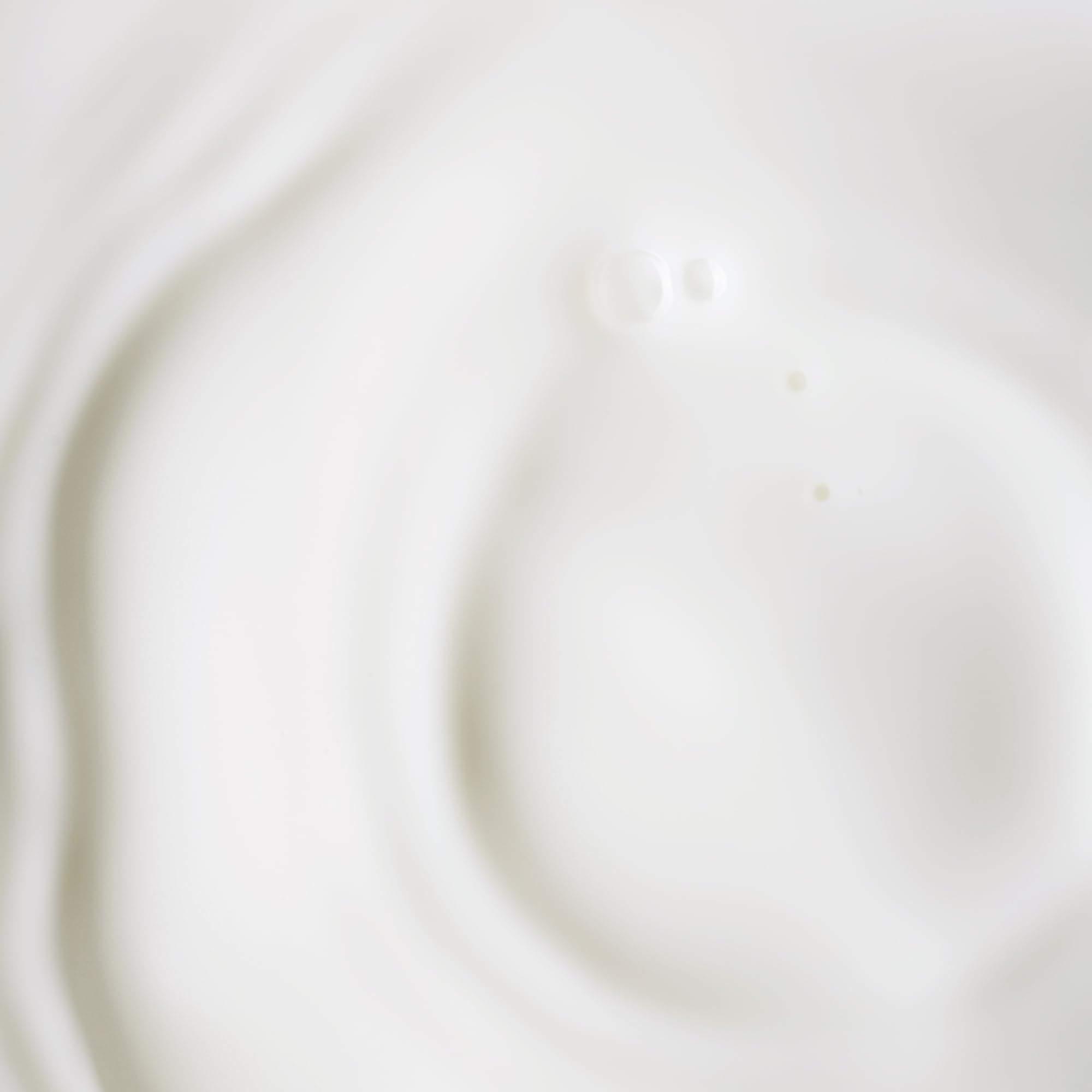KORA Organics bottle next to a coin for visible size comparison