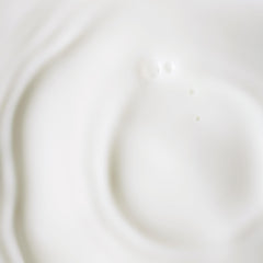 KORA Organics bottle next to a coin for visible size comparison