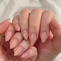 KQueenest nails held in hand illustrating size and comfortable short almond benefit