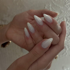 KQueenest hand holding medium almond tip showing scale and natural fit benefit